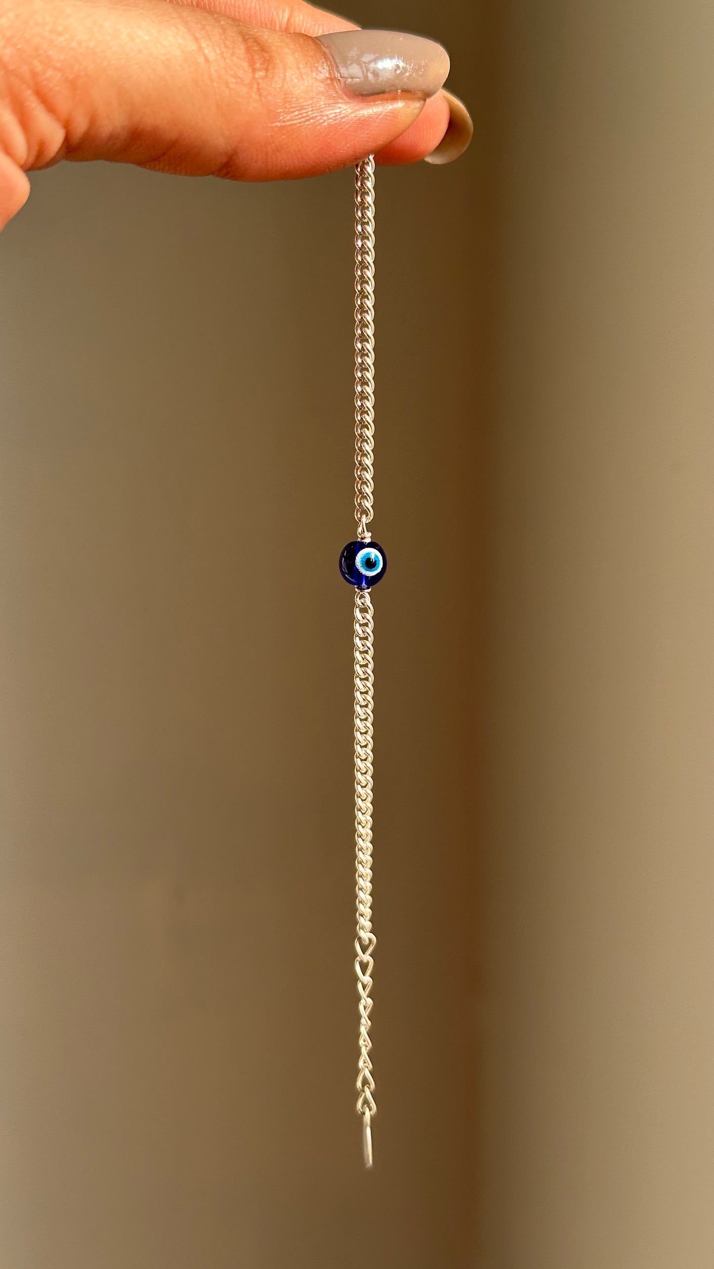 tiny evil eye bracelet close-up — small blue evil eye charm for children