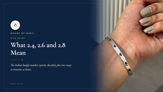 A silver Tiny Hearts Kada laid flat beside a measuring tape and thread, showing Indian bangle sizes 2.4 to 2.8.