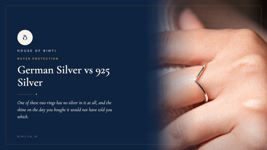 Two plain silver-coloured rings side by side on grey, one real 925 and one German silver, dulled differently by wear