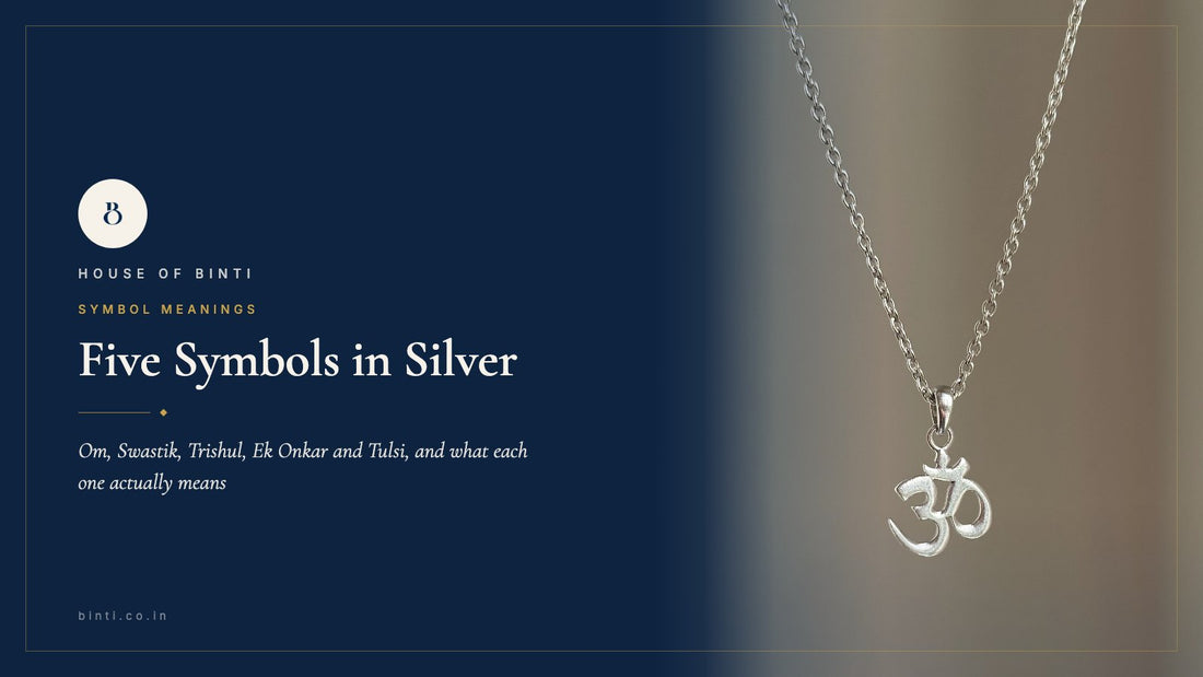 Flat-lay of five 925 silver pieces: Om neckpiece, Swastik pendant, Ek Onkar band, Trishul stud, Tulsi bracelet