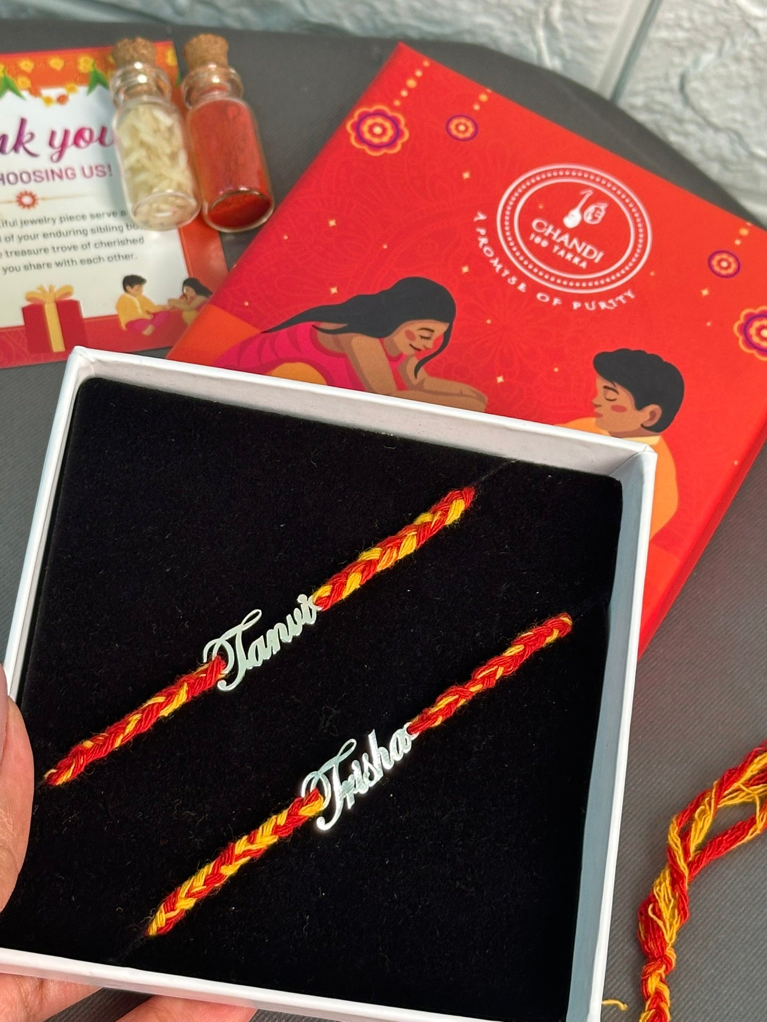Personalized Name Charm Rakhi on red and yellow braided thread, House of Binti