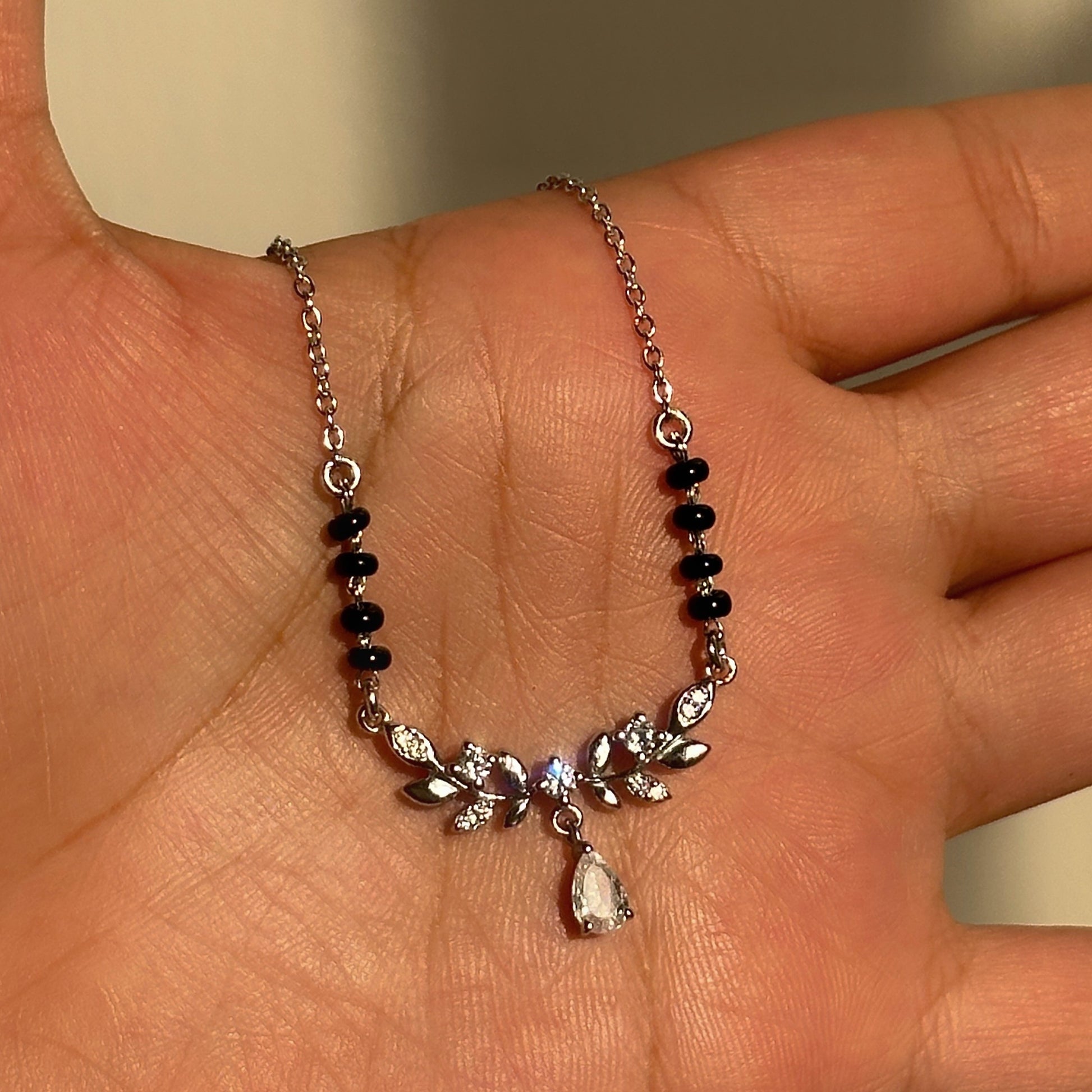 Gleam Drop Mangalsutra in 925 sterling silver with floral teardrop pendant and black beads, House of Binti