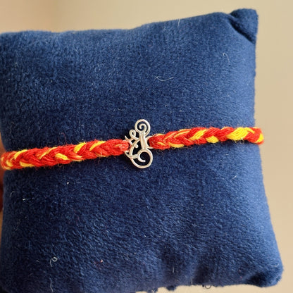 Shri Ganesh Rakhi close-up — silver Shri and Ganesha motif detail