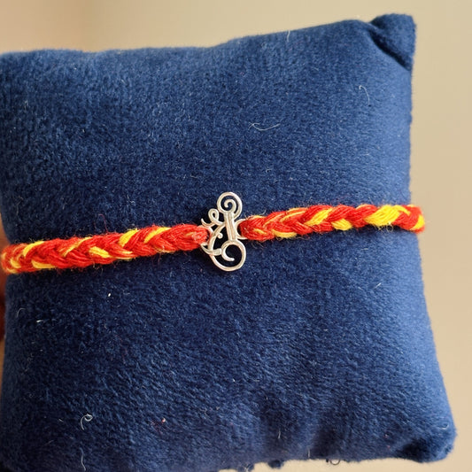 Shri Ganesh Rakhi close-up — silver Shri and Ganesha motif detail