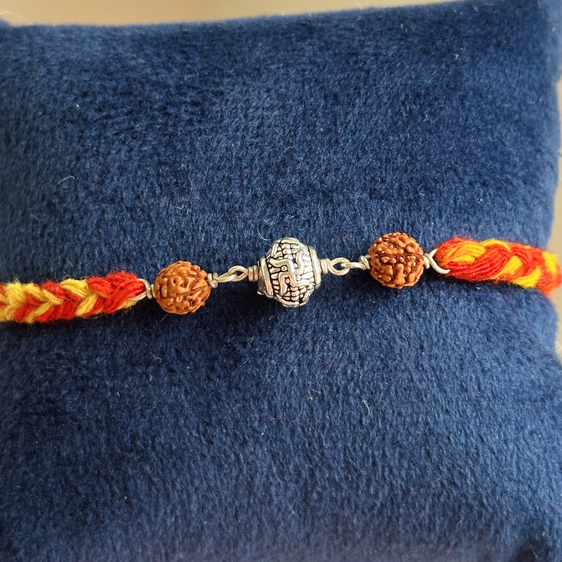 Divine Swastik Rudraksha Rakhi close-up — swastik and rudraksha bead detail