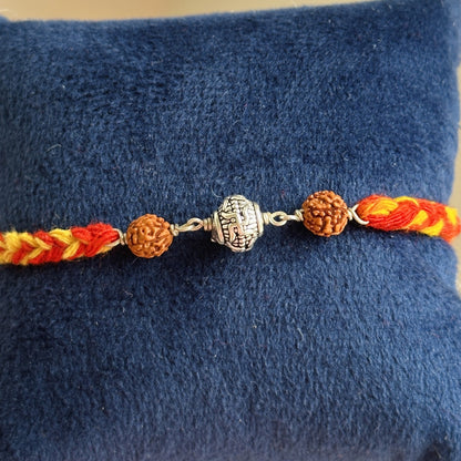 Divine Swastik Rudraksha Rakhi close-up — swastik and rudraksha bead detail