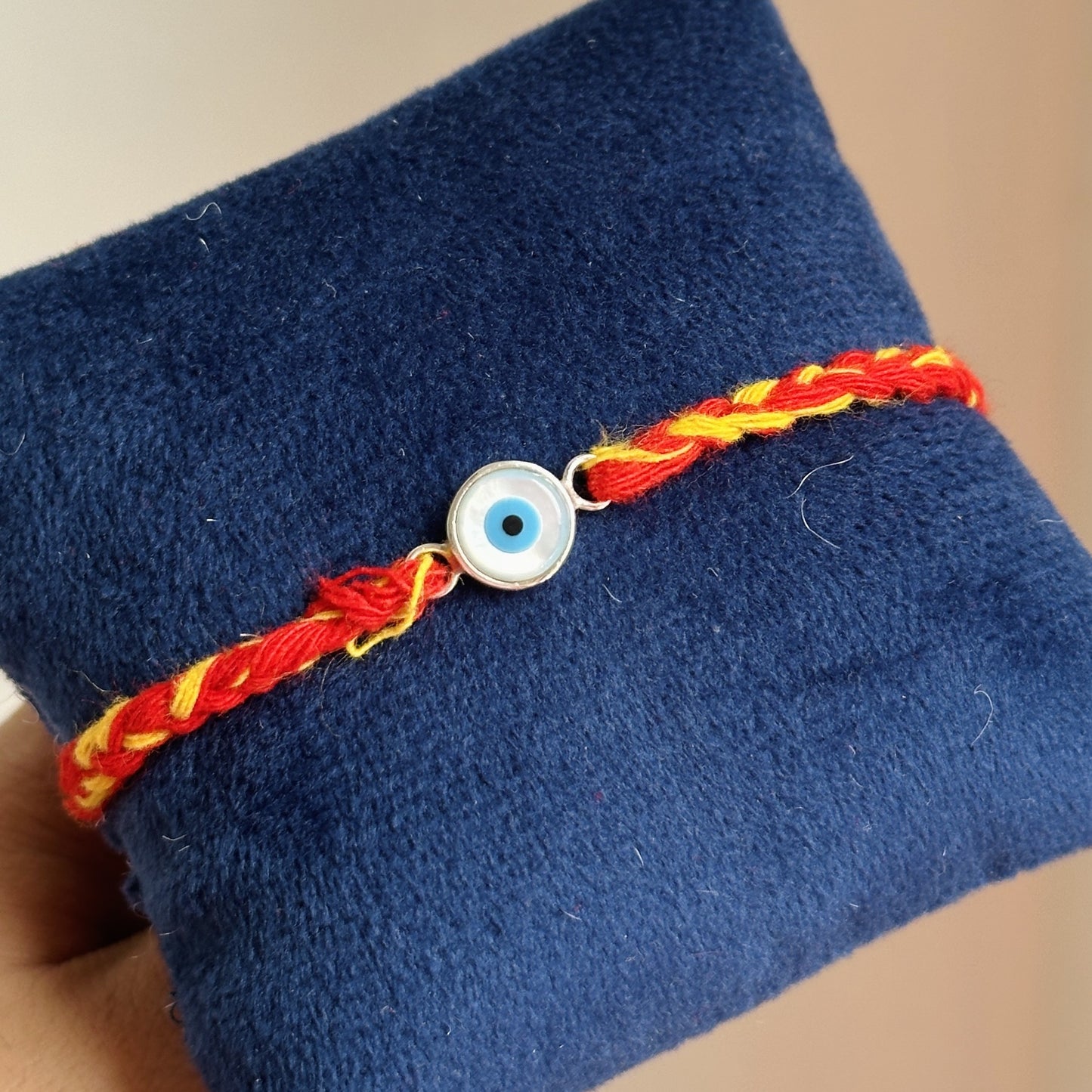 eternal evil eye rakhi 8mm close-up — blue evil eye stone detail