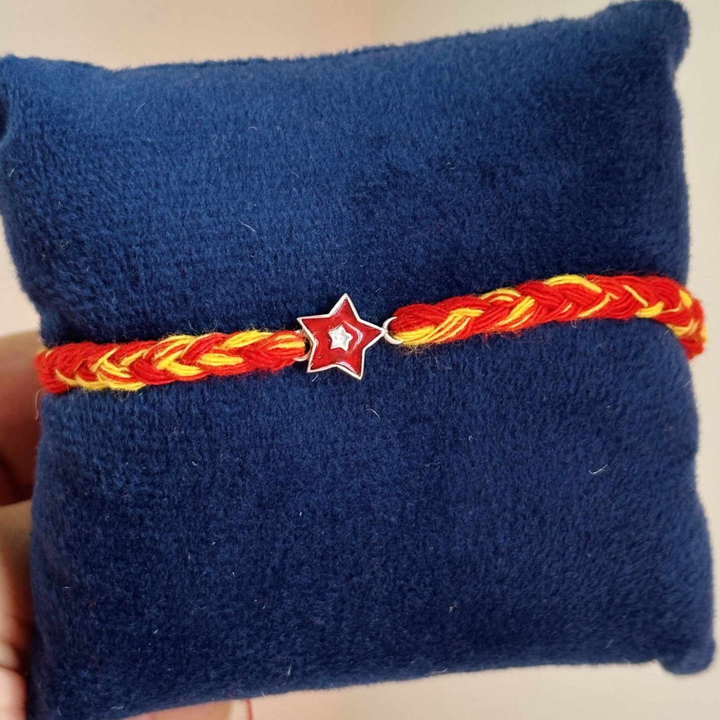 twinkle star rakhi close-up — enamel star motif detail