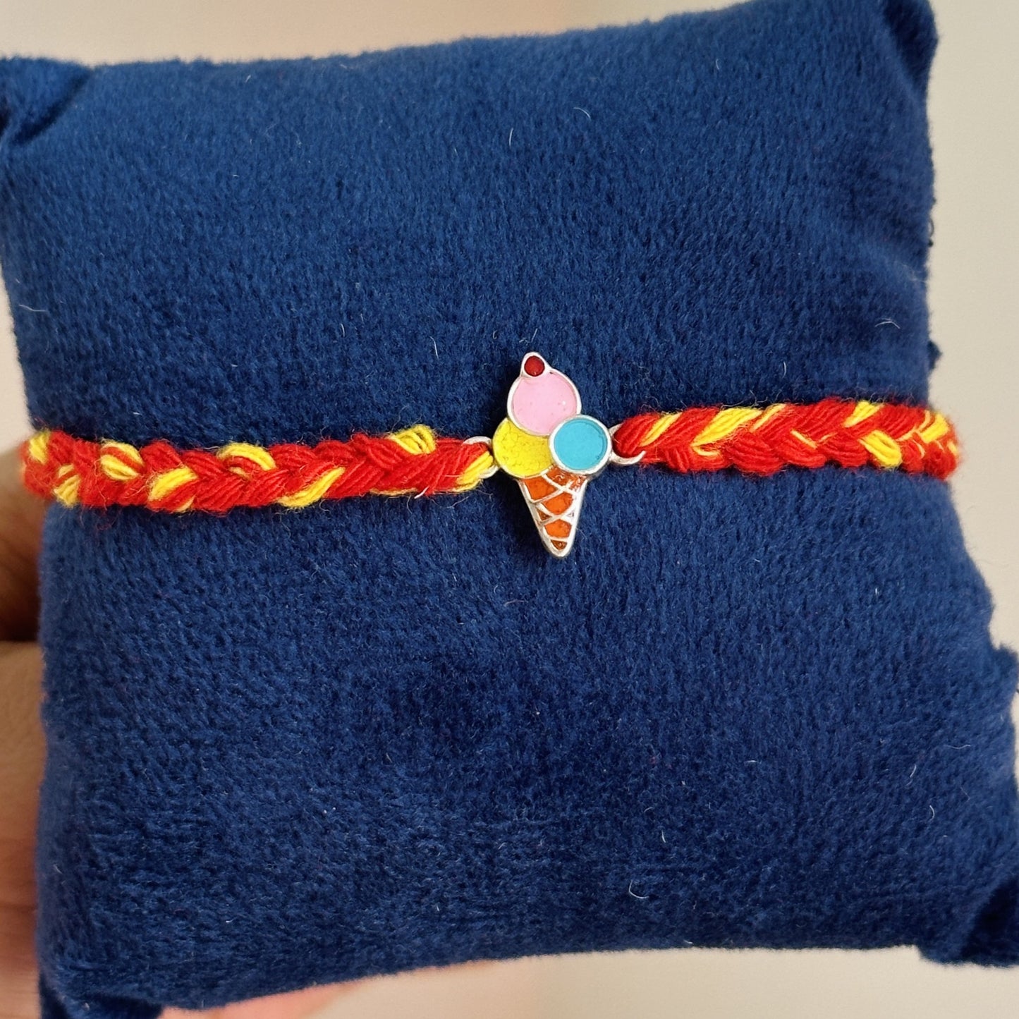 ice cream delight rakhi close-up — colourful enamel ice cream motif