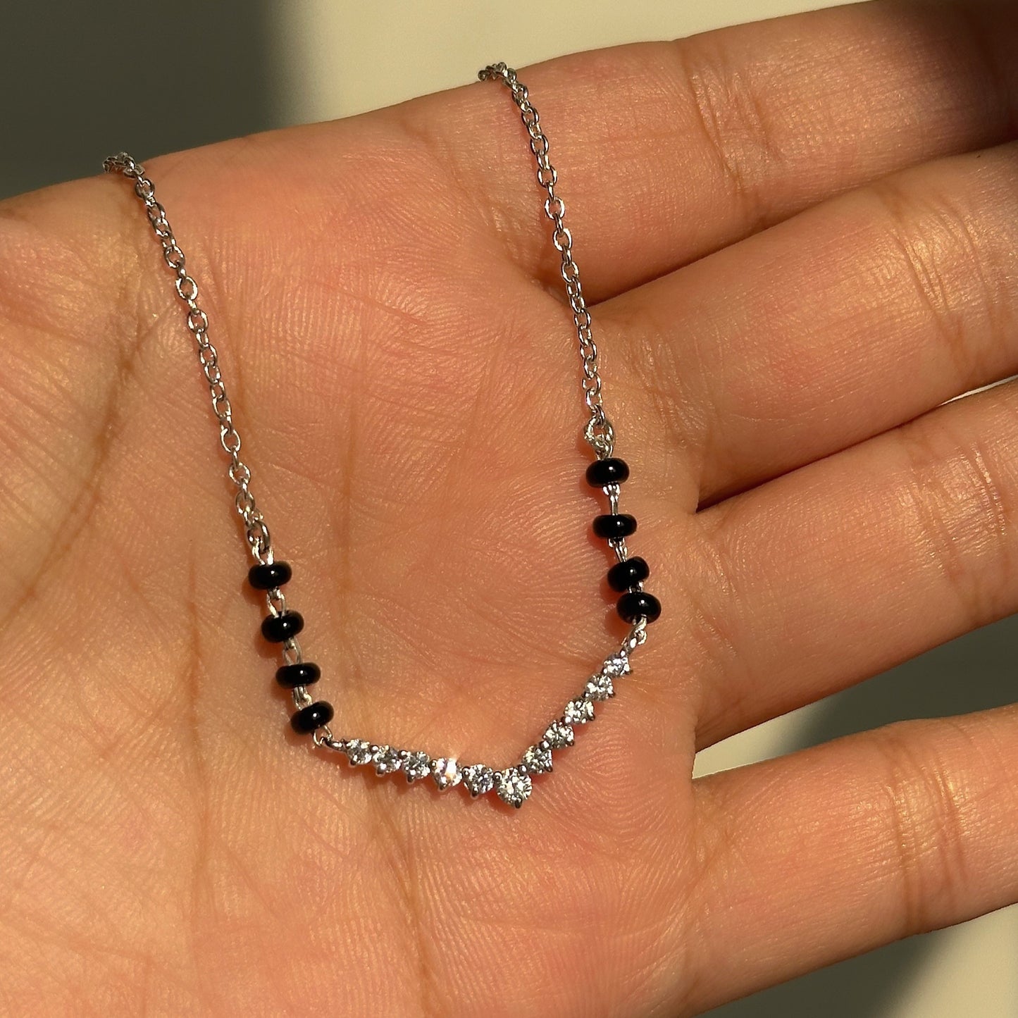 v spark mangalsutra close-up — v-shaped row of zircon stones