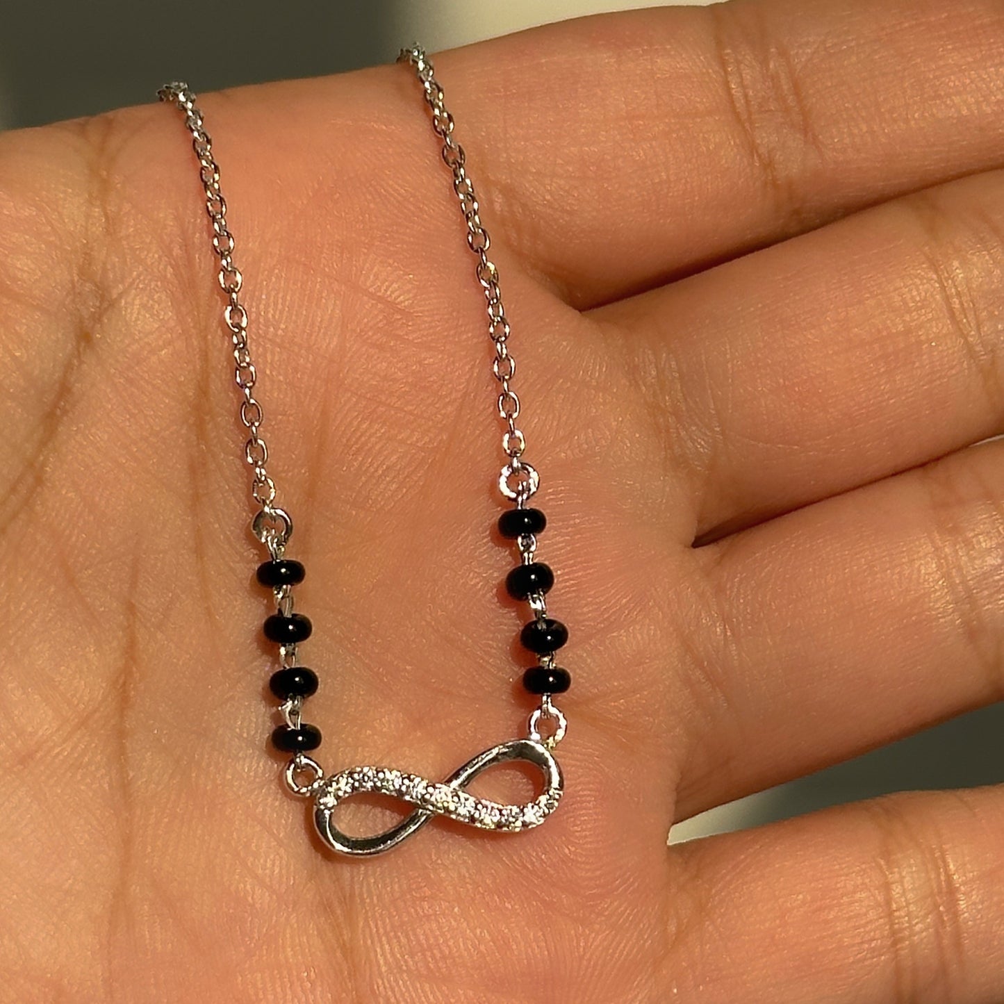 infinity grace mangalsutra close-up — sparkling infinity motif detail