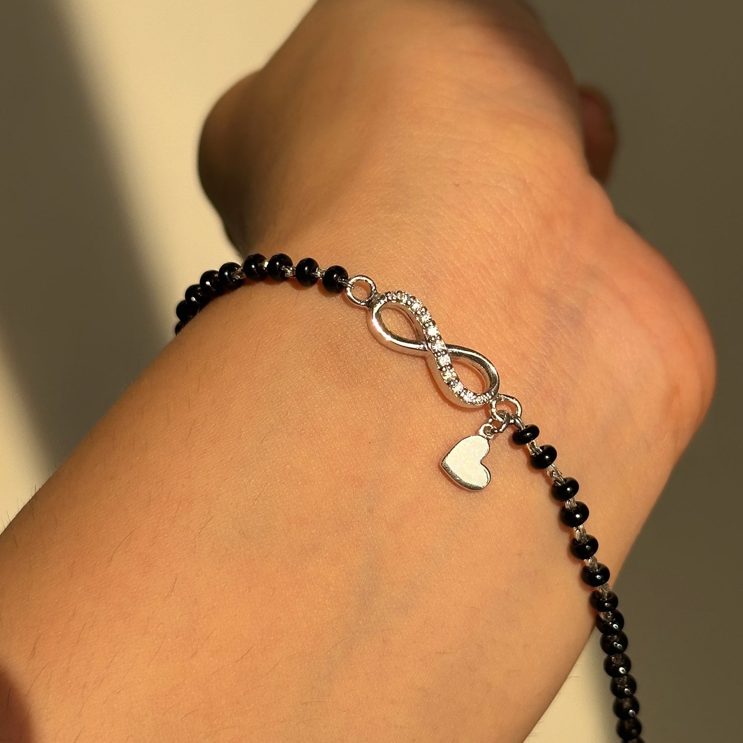 infinity heart mangalsutra bracelet close-up — personalised heart charm