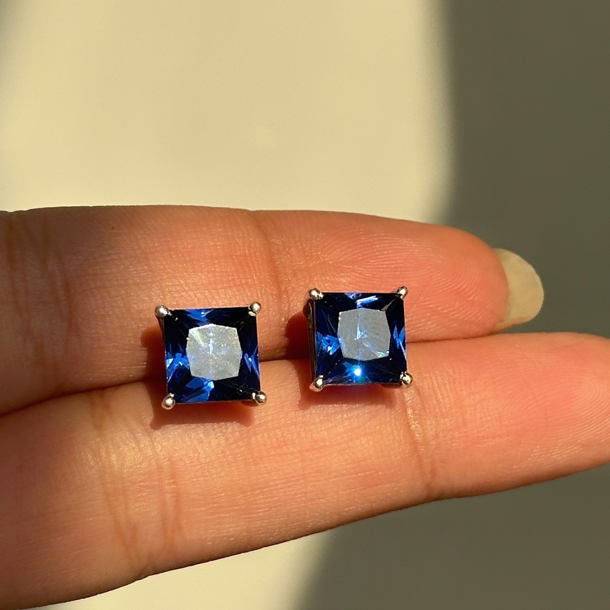 Sapphire Square Studs close-up — blue zircon square-cut stone detail