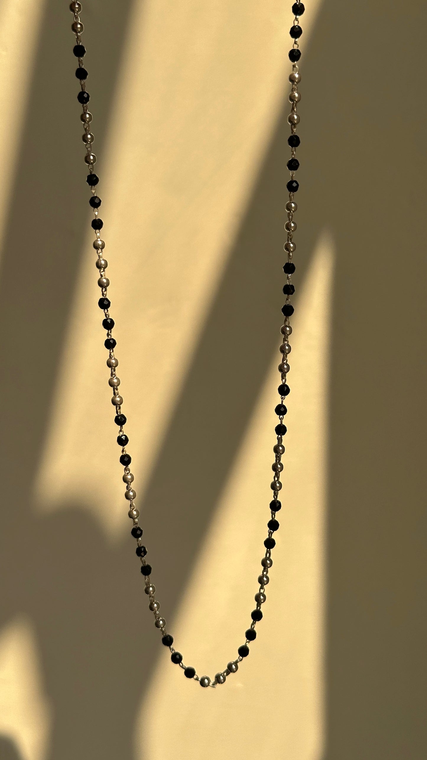 classic black bead chain close-up — alternating silver and black bead detail