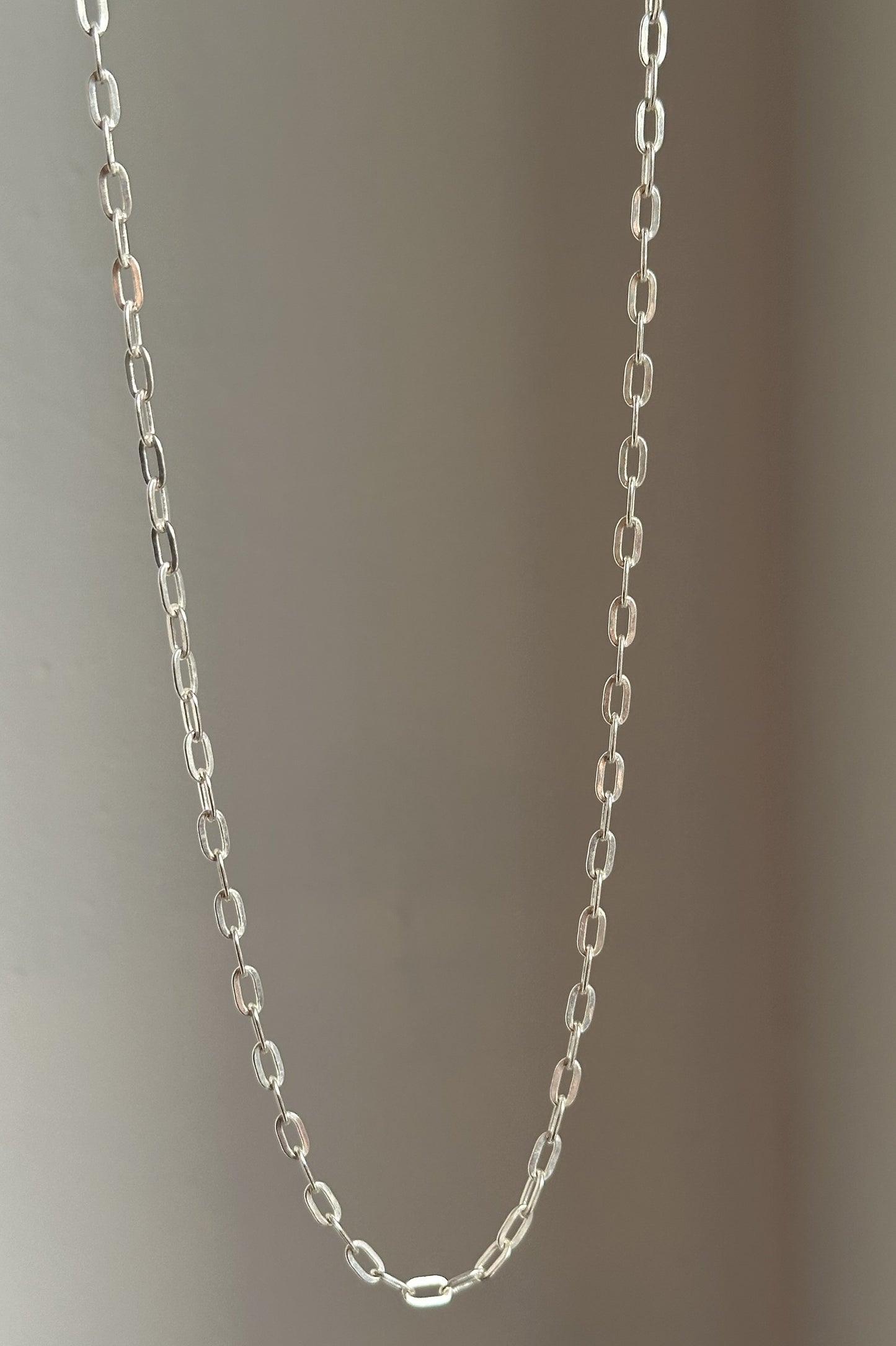 classic clip chain close-up — elongated clip link detail in silver