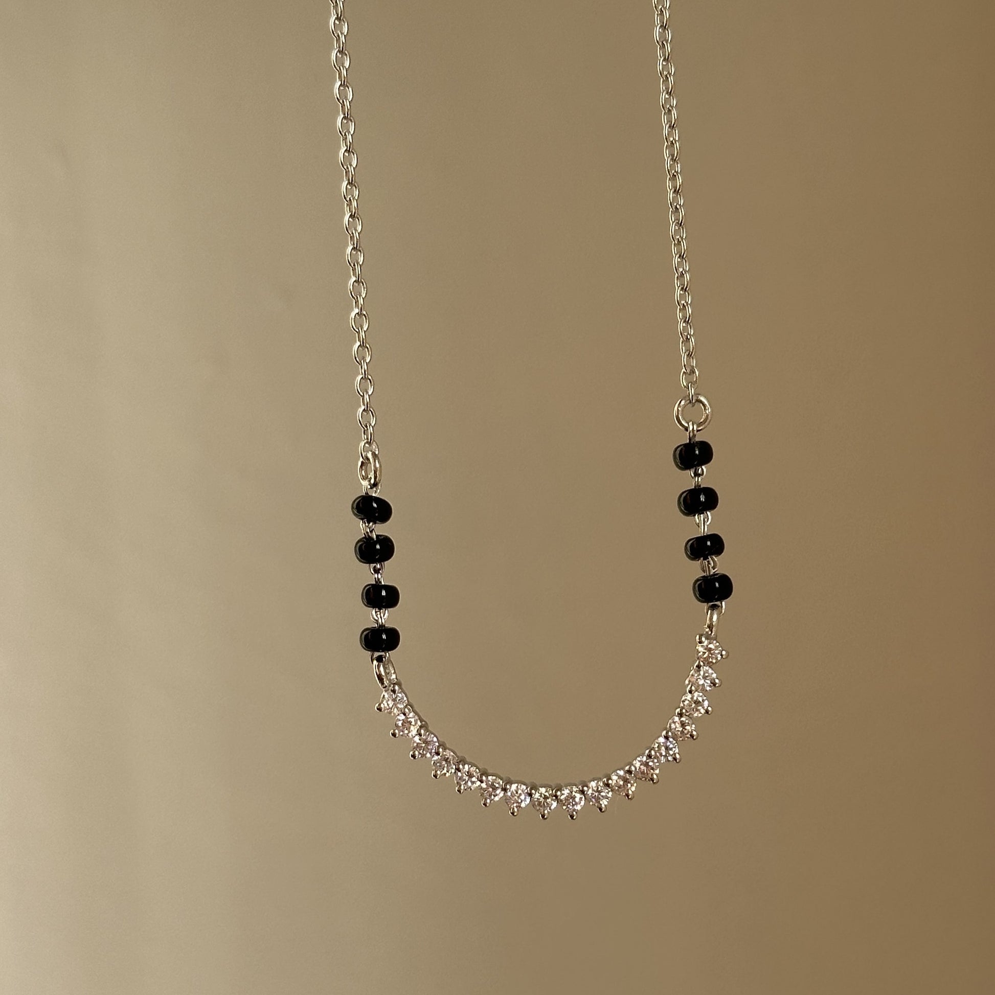 Spark Curve Mangalsutra — U-shaped stone motif in 925 silver with black beads