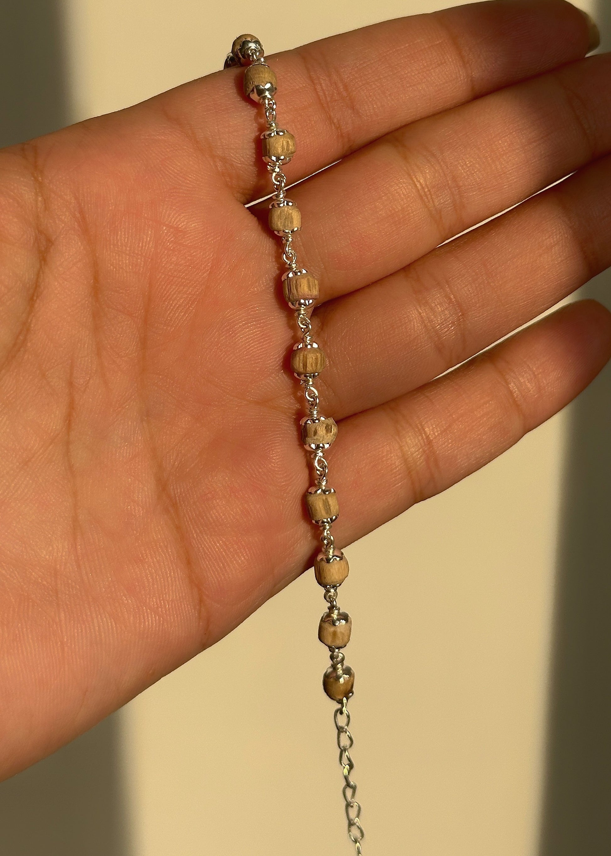 Sacred Tulsi Bracelet close-up — tulsi bead and silver accent detail